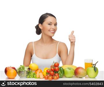 woman gives thumbs up with lot of fruits and vegetables