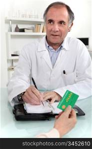 Woman giving a card to a doctor