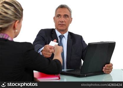 Woman giving a man her businesscard
