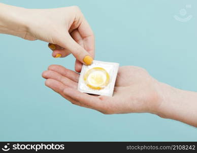 woman giving condom another person