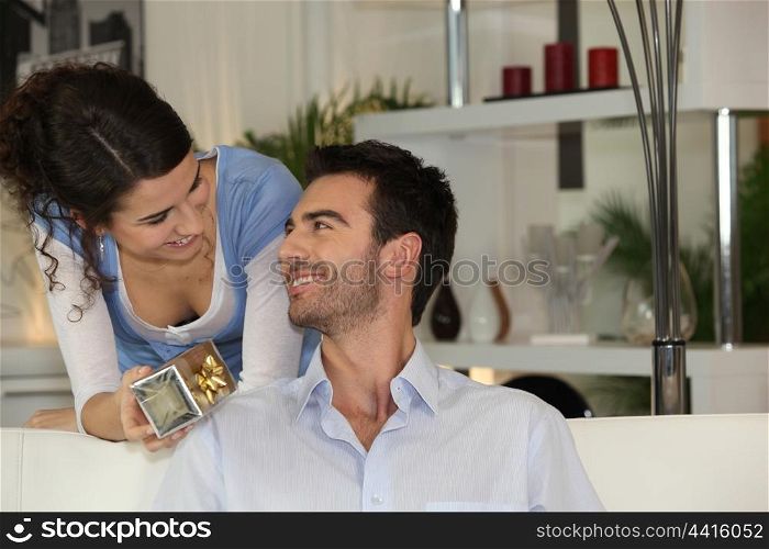 Woman giving gift to boyfriend