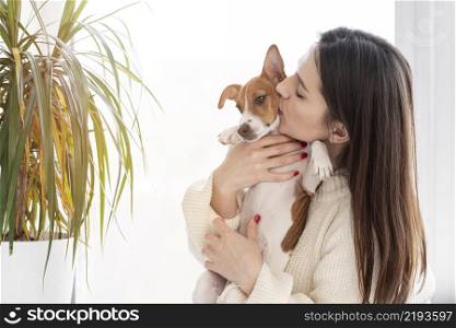 woman giving her cute dog kiss