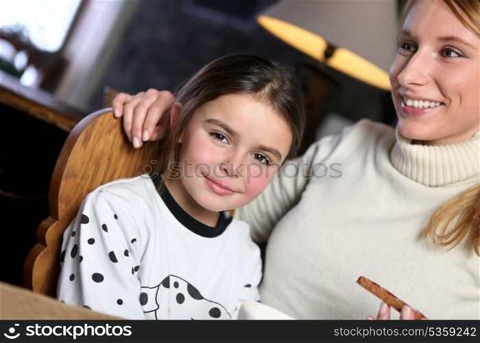 Woman giving her daughter a snack