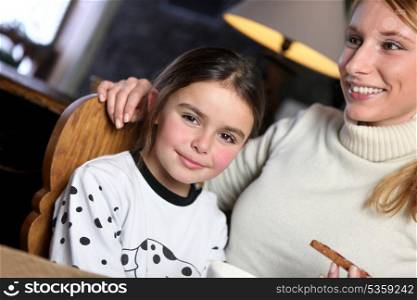 Woman giving her daughter a snack