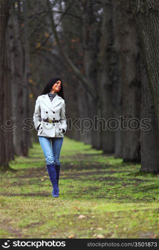 woman going by autumn park
