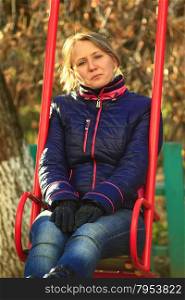 woman going for a drive on the swing. woman going for a drive on the swing in the autumn park