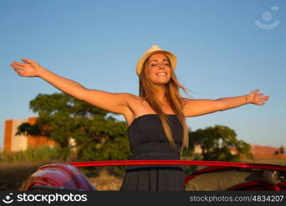 Woman going on a roadtrip in her convertible car