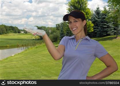 Woman golfer holding a golf ball in her hand