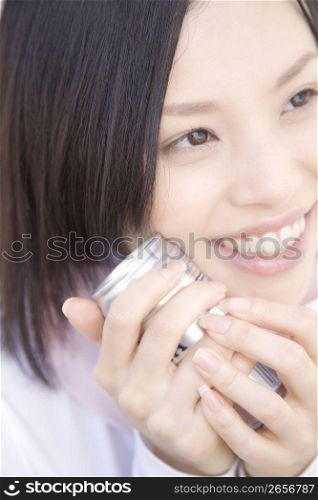 Woman gripping a can coffee