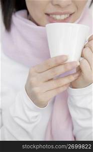 Woman gripping a coffee cup