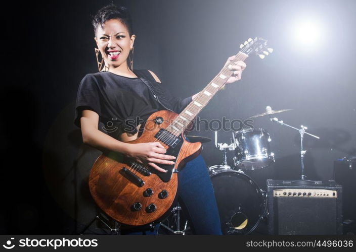 Woman guitar player during concert