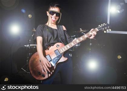 Woman guitar player during concert