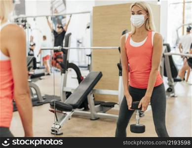 woman gym training with mask