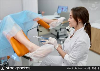 Woman gynecologist taking s&le of biomaterial from patient urogenital tract for PCR examination. Selective focus closeup view on hands. Medical concept. Woman gynecologist taking s&le of biomaterial from patient urogenital tract