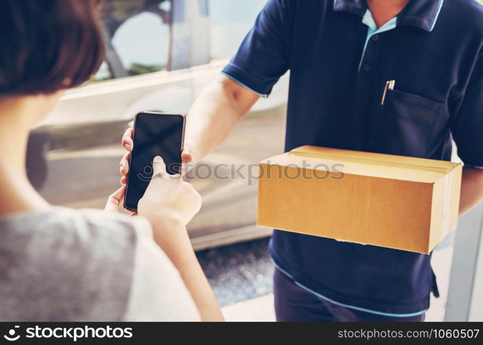 woman hand appending signature in mobile phone for receiving parcel