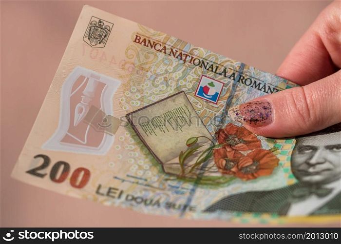 Woman hand giving money like bribe or tips isolated . LEI currency banknotes close up. Reward for hard work, finance and business concept
