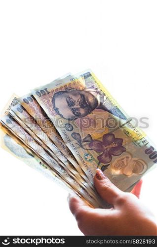 Woman hand giving money like bribe or tips isolated on white background. LEI currency banknotes close up. Reward for hard work, finance and business concept