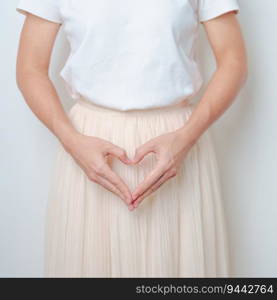 Woman hand heart shape over abdomen. Ovarian and Cervical cancer, Endometriosis, Hysterectomy, Uterine fibroids, Reproductive, menstruation, Stomach, Pregnancy and Sexual Transmitted disease concept