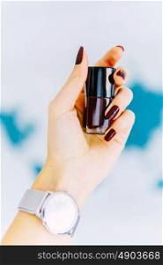Woman Hand Holding A Bottle Of Red Nail Polish