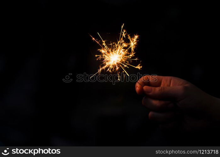 Woman hand holding a burning sparkler