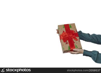 Woman hand holding a Christmas gift with red bow and isolated on white background With clipping path included. copy space Holiday concept space for text. Woman hand holding a Christmas gift with red bow and isolated on white background With clipping path included. copy space Holiday concept