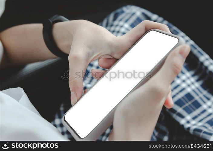 woman hand holding a mobile phone in the car cabin.Blank with white screen.Mock up smart phone interior car.
