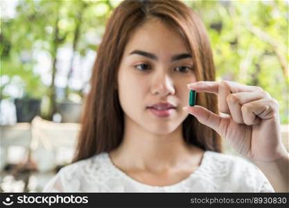 woman hand holding a pills take medicine according to the doctor’s order