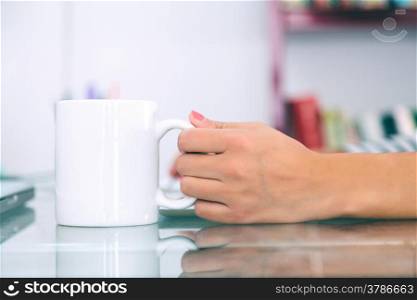 Woman Hand Holding a White Cup