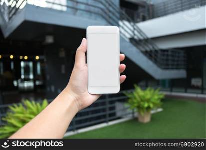 woman hand holding blank screen mobile smartphone with blurred background