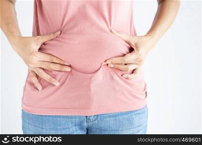 Woman hand holding her own belly fat and cellulite on white background. Women before weight loss and shape up healthy stomach muscle concept.
