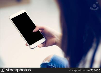 Woman hand holding smart mobile phone with message or email, girl cell telephone with copy space for content, mockup smartphone, communication concept.