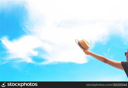 Woman hand holding straw hat, hands up, freedom and happy concept