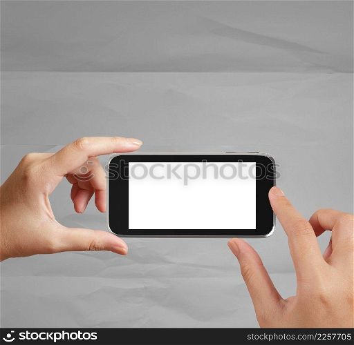 woman hand holding the phone tablet touch computer gadget on crumpled paper background 