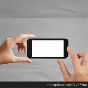 woman hand holding the phone tablet touch computer gadget on crumpled paper background 