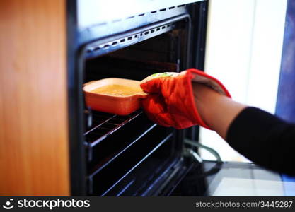 woman hand in gloves try to bake creme brulee
