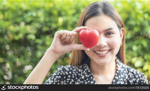 woman hand is holding red heart, love and health care concept