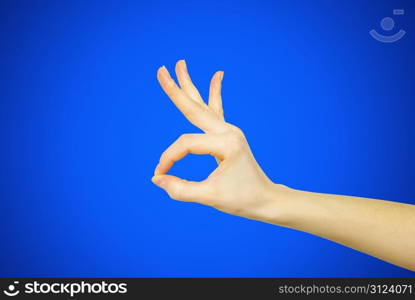 woman hand ok on blue isolated