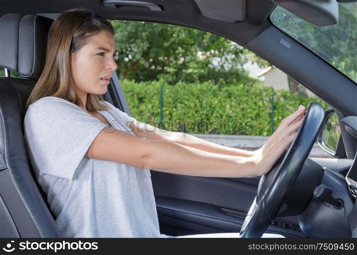 woman hand pressing a car horn