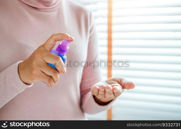 Woman hand Spraying Alcohol antiseptic solution skin disinfection to prevent viruses and diseases