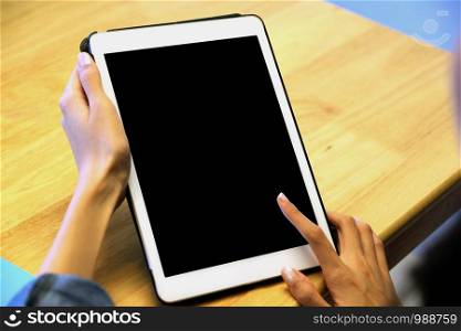 Woman hand using digital tablet with blank screen on background for mock up, template, people technology and lifestyle