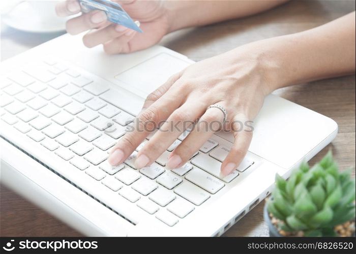 Woman hand using laptop computer and holding credit card, Online shopping