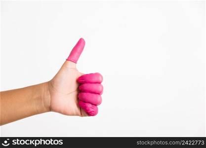 Woman hand wearing pink finger cots rubber protect help prevent fingerprints on the finger touched piece with thumb up sign gesturing, studio shot isolated on white background
