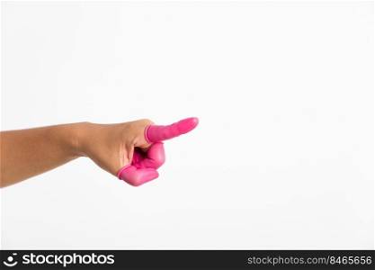 Woman hand wearing pink finger cots rubber protect help prevent fingerprints on the finger touched piece with poinging finger, studio shot isolated on white background