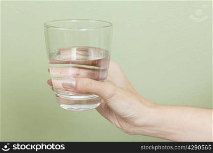 Woman hand with glass of water