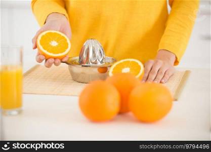 woman hand with juice glass and oranges