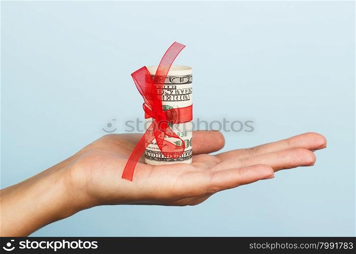 woman hand with money on the blue background. woman hand with money on the blue background. Dollar bills