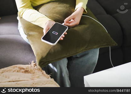 Woman hands Charging mobile phone battery with low battery. plugging a charger in a smart phone  with energy bank powerbank power charger Modern lifestyle energy technology concept