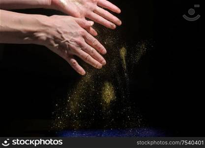 Woman Hands Drop Glitter Sparkles on Black Background