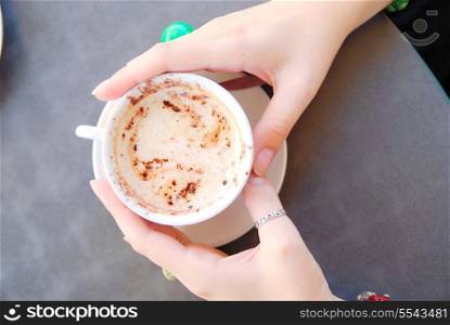 woman hands hold cup of cappucino