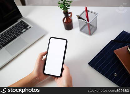 Woman hands holding blank screen mobile phone.